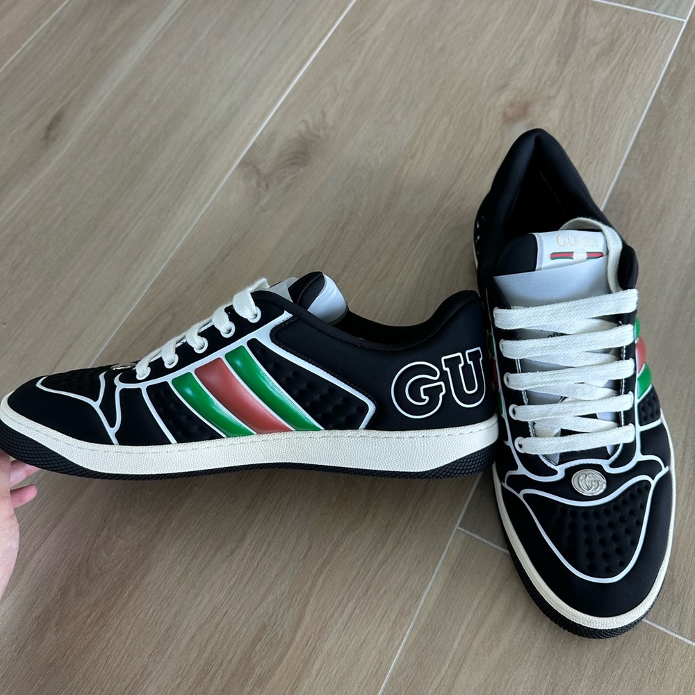Gucci black neoprene with an opaque and technical appearance.